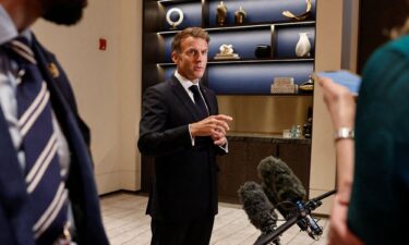 French President Emmanuel Macron speaks to members of the media in Lusail