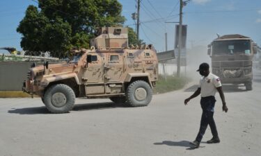 Armored police vehicles that are part of the Gang Suppression Force (GSF) patrol near the airport in Port-au-Prince