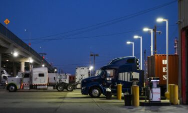 A driver refuels a vehicle with regular gasoline at a Chevron gas station in San Francisco on September 10